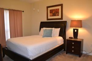 a bedroom with a bed and a lamp on a night stand at The Reside Fully Furnished Condos - Medical Stays Welcome in Houston