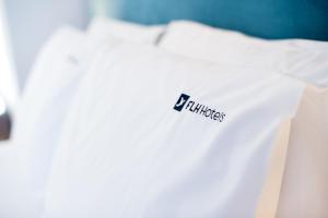 a white shirt with a fila logo on it at Reserva FLH Hotels Ericeira in Ericeira