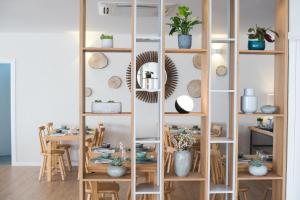 a room with a wooden shelving unit with a table at Reserva FLH Hotels Ericeira in Ericeira