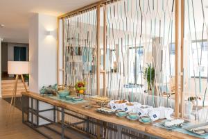 a room with a table with food on it at Reserva FLH Hotels Ericeira in Ericeira