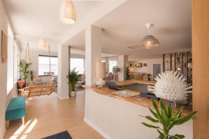 an open living room with a kitchen and dining room at Reserva FLH Hotels Ericeira in Ericeira +32 photos