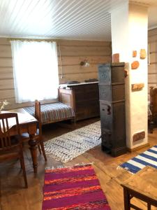 a kitchen with a stove and a table and a room at Ligedama külalistemaja in Koljaku