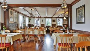 a restaurant with tables and chairs in a room at Grüner Hof in Zell am Harmersbach