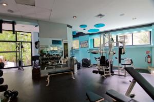 a gym with treadmills and machines in a room at Casa Cupula LGBT Luxury Resort in Puerto Vallarta