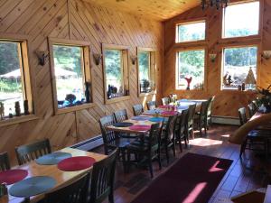 a dining room with tables and chairs and windows at Halfway House Motel in Elizabethtown