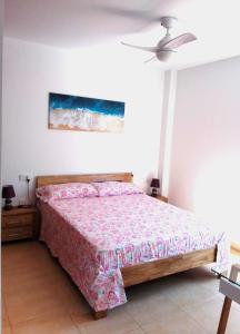 a bedroom with a bed and a ceiling fan at Casa Martina in Vejer de la Frontera +9 photos