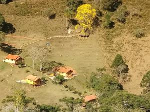 an aerial view of a group of houses in a field at Pousada Recanto do Ypê in Aiuruoca
