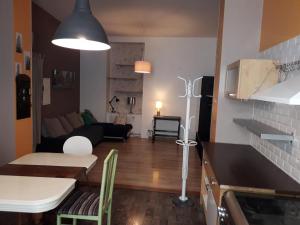 a kitchen and living room with a table and a couch at Hôtel des Jacobines in Chalon-sur-Saône