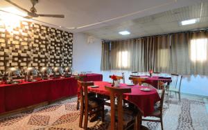 a dining room with red tables and chairs at Hotel Pablas International, New Delhi, Near Metro in New Delhi