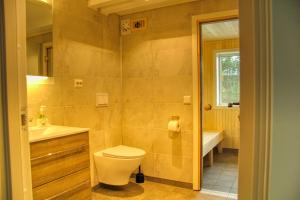 a bathroom with a toilet and a sink and a tub at Lakeside Haven Vrådal in Vradal +44 photos