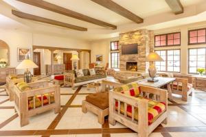 a living room filled with furniture and a fireplace at Clocktower Inn Ventura in Ventura