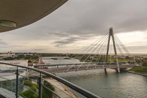 a suspension bridge over a river in a city at Waterfront Southport Hotel in Southport