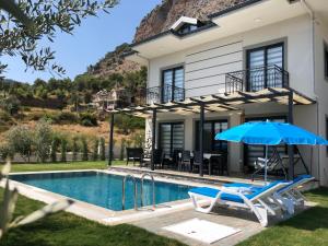 a villa with a swimming pool and a house at Private Villa in Gocek Villa Perest in Göcek