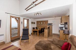a living room with a couch and a table at Les Chalets de Wengen - La Panoramique in Les Coches