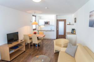 a living room and kitchen with a table and a couch at Gasthaus Seeblick in Hagnau