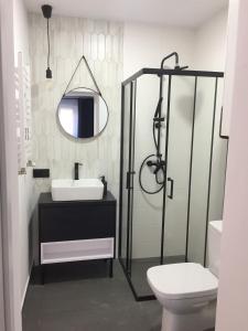 a bathroom with a sink and a mirror and a toilet at Apartament loft Krzeszowice centrum in Krzeszowice