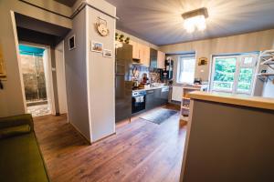 a kitchen with a refrigerator and a counter top at Arca Sweet Apartment in Gura Humorului