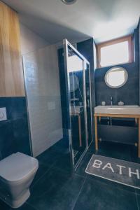 a bathroom with a toilet and a shower and a sink at Stylish apartments at Penati Golf Resort in Šajdíkove Humence