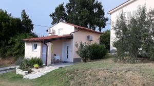 une petite maison blanche avec une cour dans l'établissement House Barizoni, à Ankaran