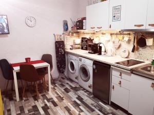 a kitchen with a washing machine and a table at PIJAMA HOUSE in Plovdiv
