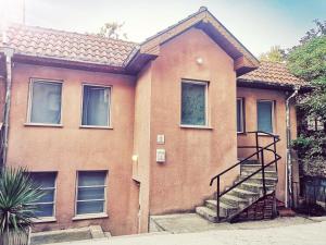 a brick house with a staircase in front of it at PIJAMA HOUSE in Plovdiv