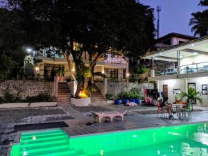 a house with a swimming pool at night at Bentrina Diving Resort in Mabini