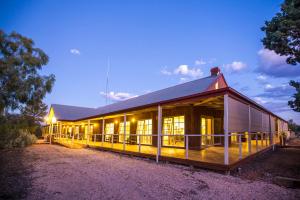 a train station with a building and a fence at Mungo Lodge in Mungo