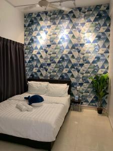 a bedroom with a bed with a blue stuffed animal on it at RetroHOUSECoCo经典怀旧风格民宿NearJONKER&AFAMOSA鸡场街红屋 by Myplace in Melaka
