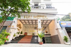 a mall hotel with stairs in front of it at Mai Hotel - Airport in Ho Chi Minh City