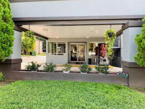 a store front with plants in a yard at Value Lodge - Gainesville in Gainesville