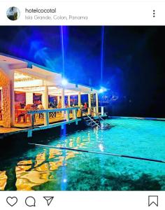 a view of a pool at a resort at night at Hotel Cocotal in Isla Grande