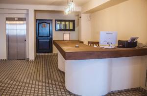 an office with a reception desk and a blue door at Múcara hotel in Veracruz
