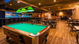 a pool table in a restaurant with a bar at Best Western Woodhaven Inn in Woodhaven