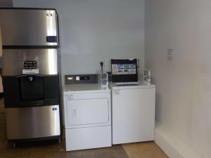 a kitchen with a refrigerator and a microwave at Economy 7 Inn in Norfolk