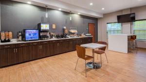 a kitchen with a counter and a table and chairs at Best Western Ingleside Inn & Suites in Ingleside