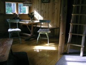 a room with a table and two chairs and a ladder at The Magical Dome in Lund