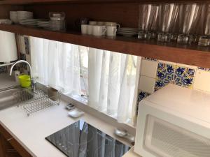 a kitchen with a sink and a microwave at Coyoacan, 2 level Cozy apartment 3Bedrooms, 3Bathrooms, Terrace in Mexico City