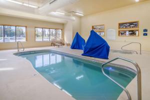 a swimming pool in a large room with blue water at Quality Inn Kenai in Kenai