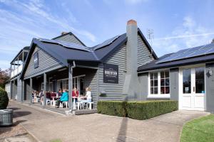 a group of people sitting at a table outside of a building at Robertson Public House and Kitchen in Robertson