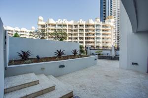 a balcony with stairs and a large building at Aria Apartments in Gold Coast
