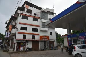 a white building in front of a gas station at Hotel R D Palace in Varanasi