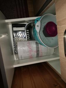 a shelf with a toaster and a roll of paper at Apartment Proljeće in Fužine