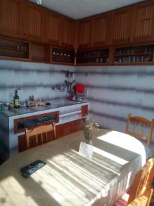 a kitchen with a table with a remote control on it at Guest House Jani in Trigrad