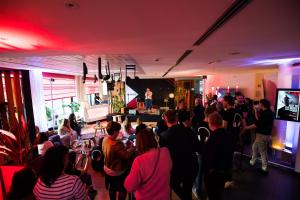 a crowd of people in a room with a stage at ibis Antwerpen Centrum in Antwerp