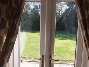 an open door with a view of a yard at Wren Cottage, Howdales in Louth