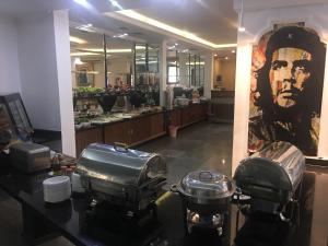 a store with a large portrait of a man on the wall at Platinum Hotel in So&ucirc;r