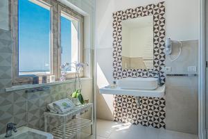 a bathroom with a sink and a mirror at Do' Petro Relax & Pool in Vico Equense