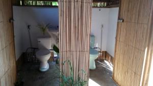 a bathroom with two toilets and two sinks at Banana Grove El Nido in El Nido