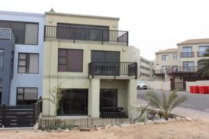 a building with a balcony on the side of it at Zee Sicht in Swakopmund