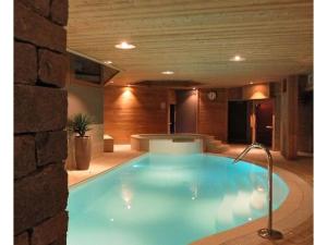 a large blue swimming pool in a building at Les Chalets du Chaberton, Pied de pistes et Spa in Montgenèvre